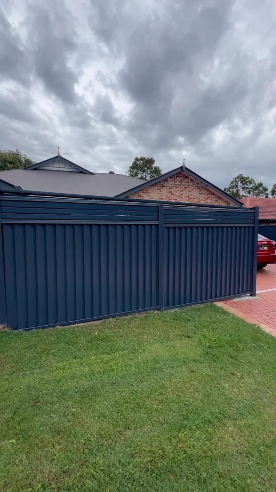 Monument colorbond fence panels along a suburban boundary